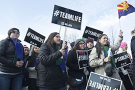 Kellie Taylor, far left, marches in the 2015 March for Life with students from St. Mary's Catholic High School in Phoenix Thursday, as they head toward the Supreme Court.