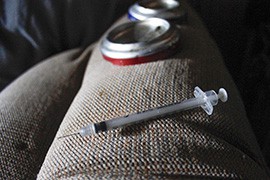 Paraphernalia used to shoot up heroin includes a syringe and part of a soft drink can, from a Yuma dopehouse in November.