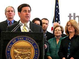 Gov. Doug Ducey speaks at a signing ceremony for legislation that will allow Arizonans to get medical tests without having to get a doctor’s order. At right is Rep. Heather Carter, R-Cave Creek, the bill’s author.