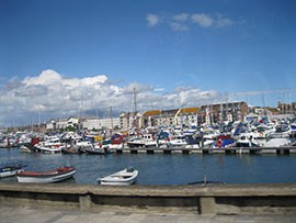 Yachts and sailing boats crowd a harbour in Weymouth, the venue for the London 2012 sailing events, on Sunday, July 29, 2012.