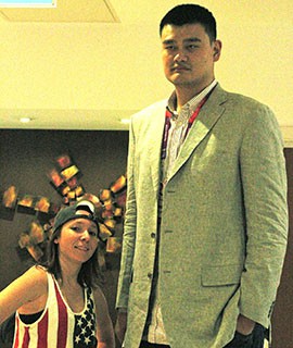 Erin Goheen of Ahwatukee Foothills, stands next to basketball player Yao Ming in London during the Olympics 2012 on Friday, July 27, 2012.
