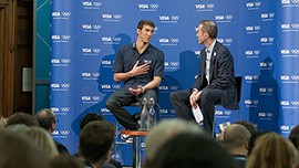 Michael Phelps talks to Visa executive Kevin Burke about his experiences at the 2012 Olympics at a news conference in London on August 5, 2012. Phelps will be retiring from Olympic competition this year.