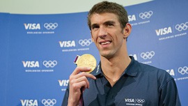 USA Olympic swimmer Michael Phelps holds up his 22nd Olympic medal. Phelps is now the most decorated Olympian of all time, having won 18 gold medals and 22 overall.