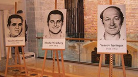 The pictures of three of the 11 men killed at the Munich 1972 Olympic Games decorate the hall at the official Munich Memorial Ceremony on Monday, August 6, 2012.