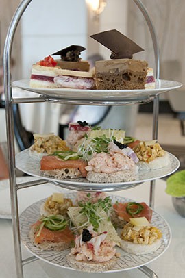 For afternoon tea at the Intercontinental London Park Lane Hotel, the cakes and sandwiches served are themed after some of the Queen's childhood favorites with a contemporary twist.