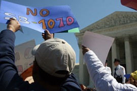 Music and religion played a big part as hundreds of singing, chanting, marching - mostly civil - protesters gathered in front of the Supreme Court to make their voices heard while the justices weighed arguments on Arizona's SB 1070 immigration law.